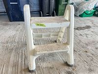Front view of white plastic two-step stool