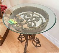 Top view showing round glass top and floral rope iron rim