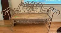 Full view of metal scrollwork garden bench