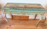 Front view of entire console table showing distressed multicolored top and legs