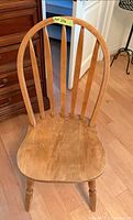 Front view of Windsor-style chair showing seat wear and spindle back
