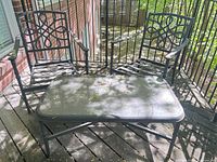 Overall view of two matching chairs and table on deck