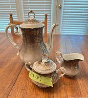 Full view of coffee pot, sugar bowl, and creamer showing design and color gradient