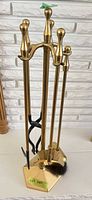 Full view of brass stand with all four tools attached