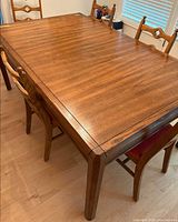 Top view of wooden dining table showing wood grain and tapered legs