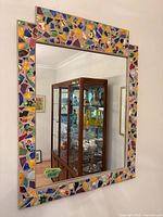 Full view of rectangular mosaic framed mirror on wall