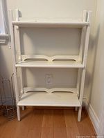 Front view of white three-tier ladder shelf