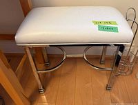 Full view of vanity bench showing white cushion and chrome frame