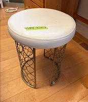 Full view of stool showing seat label and lattice base