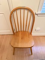 Front view showing entire chair, spindle back and contoured seat