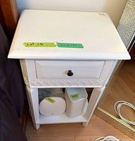 Overall view of white end table showing drawer and lower shelf