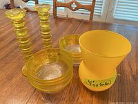 Full lot showing two candlesticks, stacked bowls, vase
