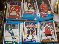 Stacks of 1989-90 O-Pee-Chee hockey cards featuring Jamie Macoun, Mikko Makela, Bobby Smith, Ulf Samuelsson, Steve Smith, Ken Wregget.