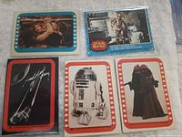 All five trading cards laid out