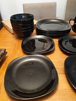 Stack of bowls, plates and individual plates visible