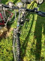 Front view showing handlebars, front wheel, V-brake and tire tread