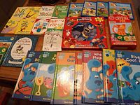 Group shot of all books, puzzle book and science kit on table