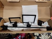 Open box displaying towel bar, toilet paper holder, hand-towel holder, robe hook and mounting hardware