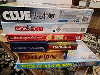 Stack of eight board game boxes showing all titles