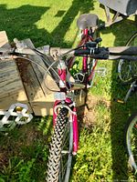 Front cockpit view showing handlebars, brake levers, shifters, front tire tread