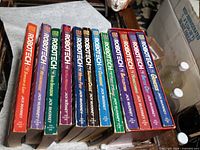 Twelve Robotech paperbacks volumes 1-12 standing spine-out