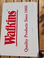 Full front view of Watkins sign showing logo and text
