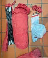 Tent body, poles, rainfly, stakes pouch and carry bag laid out