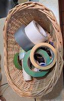 Basket containing assorted rolls of tape