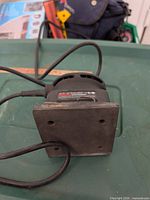 Bottom view showing square sanding pad and cord entry