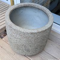 Exterior view of cylindrical ceramic pot with stone-like texture