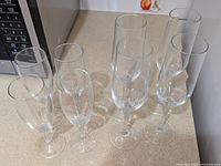 Eight champagne flutes grouped on countertop