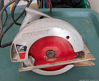 Front view showing Skilsaw branding and red Freud Diablo 7-1/4" blade