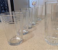 Side view showing six ribbed tumblers and three fluted tumblers lined up