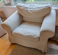 Front angled view of the armchair showing overall design, color and cushions