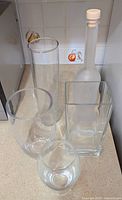 Group of all five glass vessels on countertop