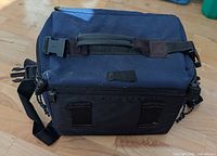 Top view of camera bag showing handle, zippers, shoulder strap attachment