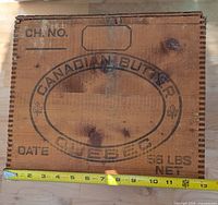 Side of box showing Canadian Butter Quebec stencil with measuring tape for scale
