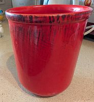 Front view of glossy red ceramic pot