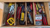 Drawer showing assorted hand tools listed