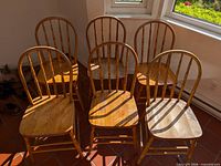 Front view of six bow-back Windsor chairs arranged in two rows