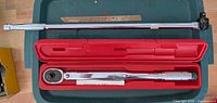 Torque wrench in red case and breaker bar overall view