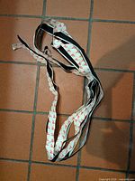 Coiled length of black hook-and-loop tape showing overall amount