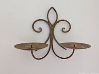 Front view of wrought iron candle holder on wall