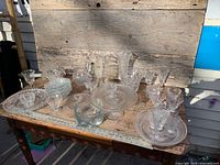 Overview of entire clear glass assortment on table