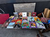 Overall view of all 25 album covers laid out on bench