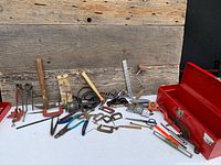 overview of entire lot on table showing variety of tools and red toolbox