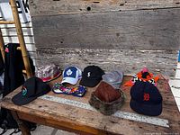 All nine hats arranged on table for overview