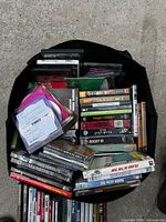 Overhead view of tote bag showing DVDs, CDs and VHS tape