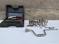 Overall view of case, sockets, pliers, wrench, extensions, speed brace