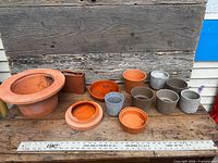 Full group of planters and saucers on table for scale